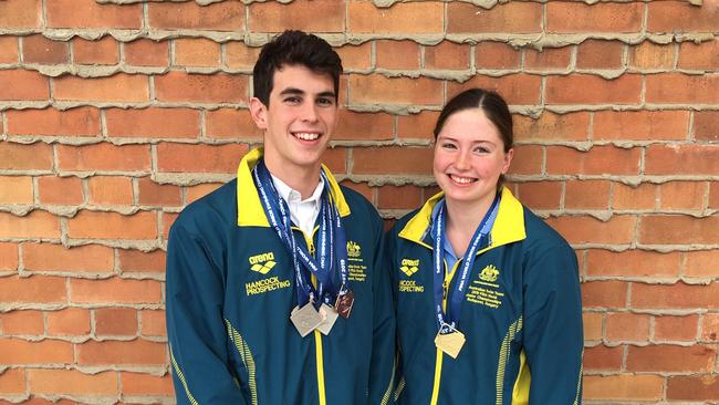 Bronte Job with her Rackley Centenary teammate Tom Neill and their medal haul after the world junior swimming championships where Job won gold.