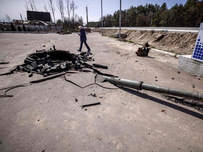 A man stands next a turret of a destroyed tank in Zalissya. Picture: AFP