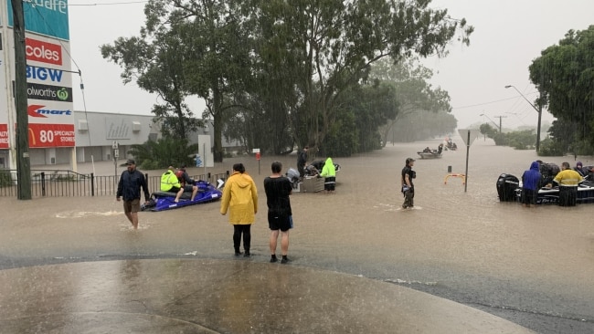 Locals said at least 30 to 50 boats raced up and down flooded roads to rescue trapped neighbours and friends who could not flee the 68-year record high waters. Picture: Stuart Cumming
