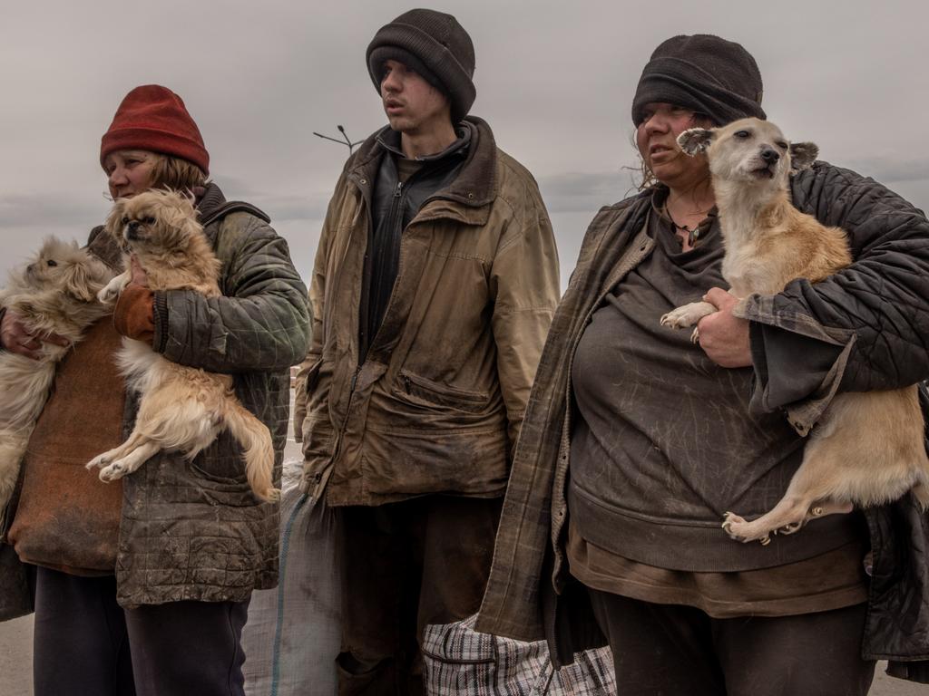 A family from Myrne, a town currently occupied by Russian forces wait to register with police at an evacuation point for people fleeing from Mariupol. Picture: Getty Images