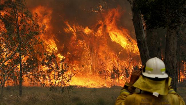 A firefighter keeps watch on a huge blaze at Old Bar. Picture: AAP