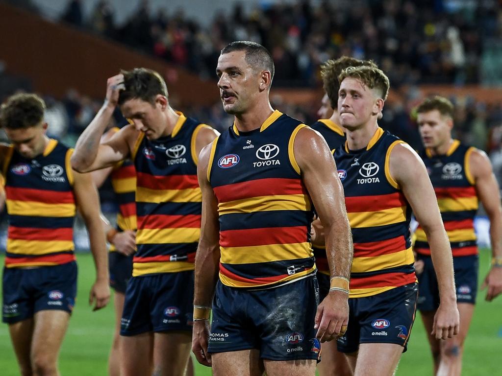 Former Crows skipper Taylor Walker leads his side off after a bitter loss to Essendon on Friday night. Picture: Mark Brake/Getty Images.