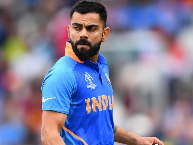 MANCHESTER, ENGLAND - JULY 10:  Virat Kohli, Indian Captain walks after being bowled lbw of the bowling of Trent Boult of New Zealand during resumption of the Semi-Final match of the ICC Cricket World Cup 2019 between India and New Zealand after weather affected play at Old Trafford on July 10, 2019 in Manchester, England. (Photo by Clive Mason/Getty Images)