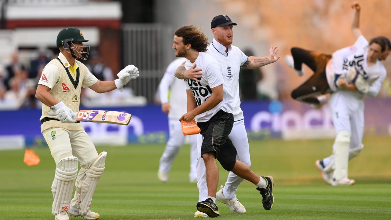 Ben Stokes of England and David Warner of Australia attempt to stop a "Just Stop Oil" protester. Photo by Stu Forster/Getty Images