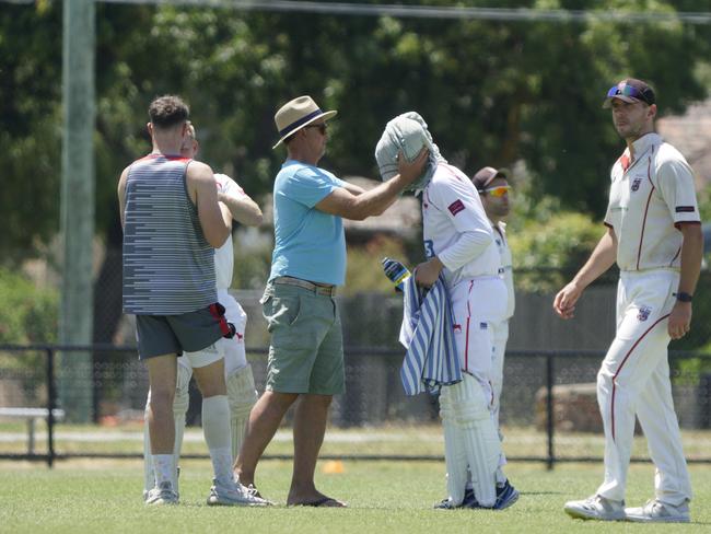 Cricket Southern Bayside cricket : Mordialloc v South Caulfield. Mordialloc batter Ryan Morris gets some help for heat stress. Picture: Valeriu Campan