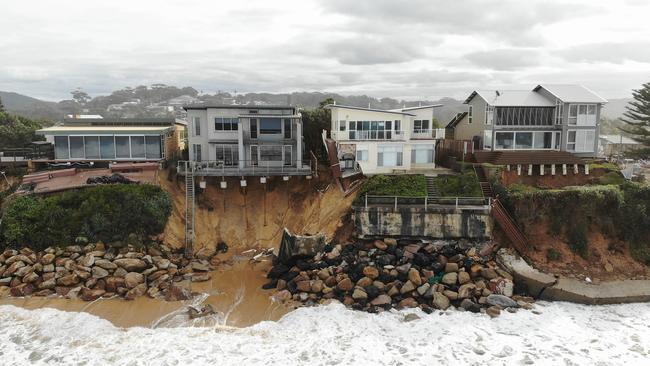 Huge swells have caused erosion and land to slip into the ocean along a row of prestige homes at Wamberal. Picture: David Swift