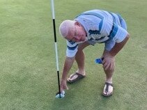 Rowan Braithwaite collects his ball after shooting a hole in one at the Gympie golf course on Tuesday.