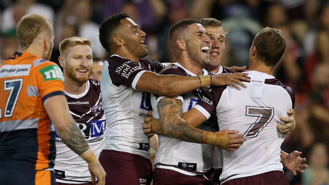 Manly Sea Eagles celebrate a try to Joel Thompson in their victory over the Knights. 