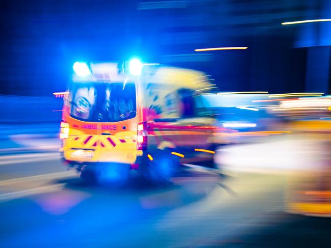 The ambulance circulating the streets at night, close-up, long exposure