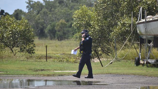 Police investigate the scene on the banks of the Burnett River and interview boaties following a serious boat crash.