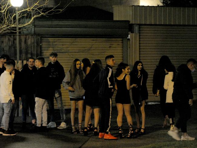 Bystanders outside a party which was gatecrashed. Picture: Andrew Henshaw