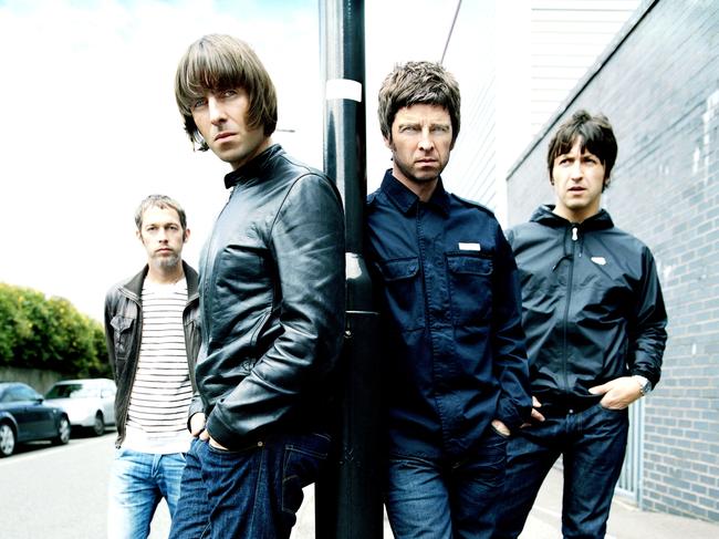 Liam Gallagher (left) and his musician brother Noel stand in front of fellow members of band Oasis. Picture: Sony BMG