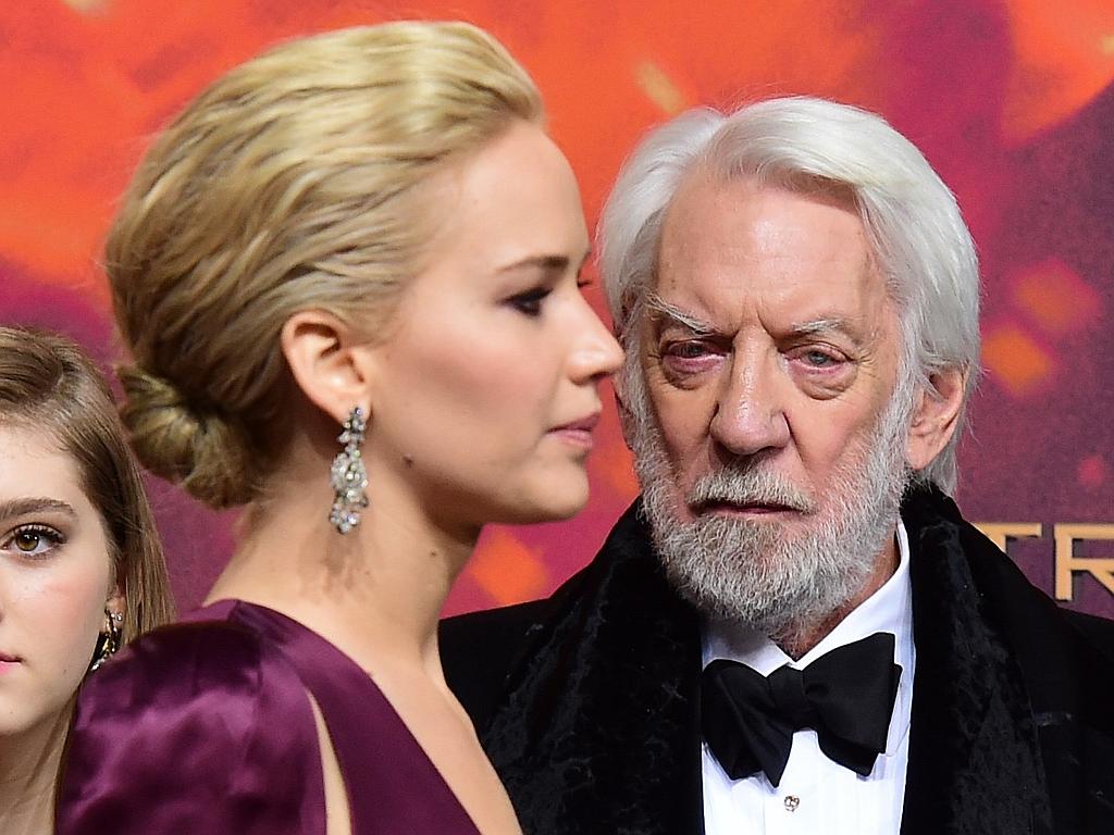 Actress Jennifer Lawrence and actor Donald Sutherland pose for photographers on the red carpet at the world premiere of the film ‘The Hunger Games: Mockingjay - Part 2’ on November 4, 2015 in Berlin. Picture: AP