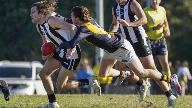 Outer East: Narre Warren’s Tom Toner can’t escape the tackler. Picture: Valeriu Campan