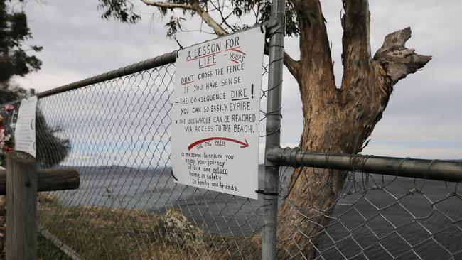 A sign posted at Blackmans Bay Blowhole following the death of Margaret Lore. Picture: MATHEW FARRELL