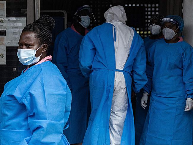Members of the Ugandan Medical staff of the Ebola Treatment Unit stand inside the ward in Personal Protective Equipment (PPE) at Mubende Regional Referral Hospital in Uganda on September 24, 2022. - On September 20, 2022, the health authorities in Uganda declared an outbreak of Ebola after a case of the Sudan ebolavirus was confirmed in the Mubende district and registering three deaths including a 12-years-old girl. (Photo by BADRU KATUMBA / AFP)