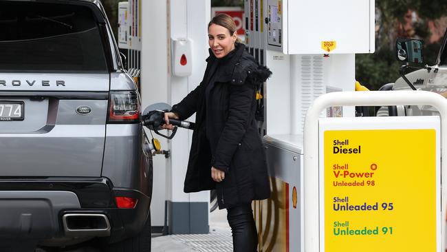 Stacey Papas fills up her car at a petrol station. Picture: Ian Currie