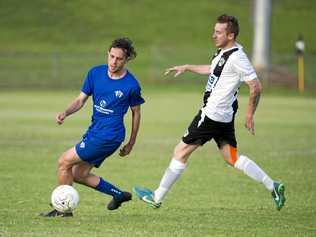 CLOSE BATTLE: Rockville's Braiden Hinch rounds Willowburn's Trent Donovan during their match at the weekend. Picture: Nev Madsen