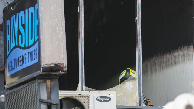 A firefighter inside Bayside Health and Fitness after the blaze. Picture: Brendan Beckett