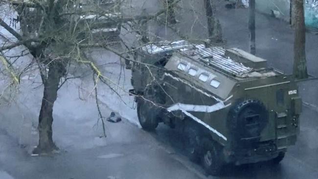 A military truck and tank are seen on a street of Kherson. Picture: Video obtained by Reuters I