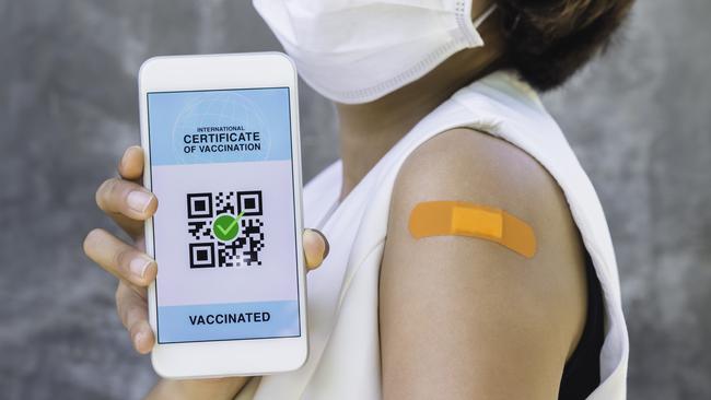A woman show her digital certificate of vaccination.