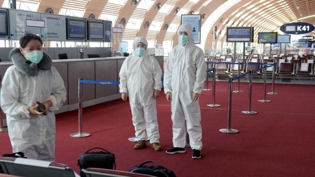 Passengers wear protective clothing before boarding a China Southern Airlines flight in France, where restrictions on Chinese travellers have just been announced. Picture: AFP