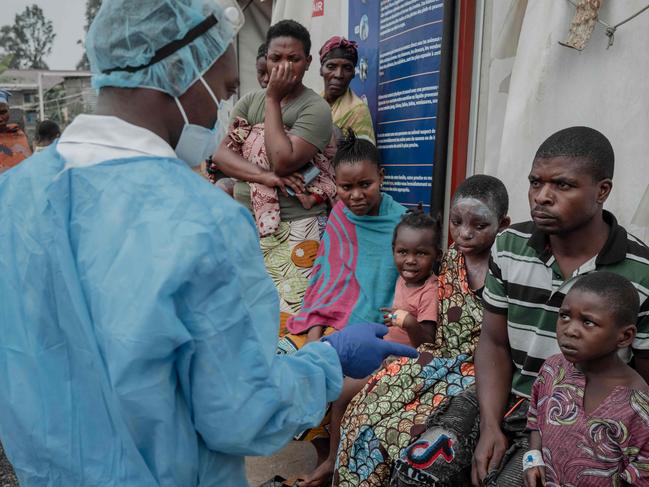 Patients listen to a doctor outside the consultation room of the mpox treatment centre at Nyiragongo General Referral Hospital, north of Goma on August 17. Picture: AFP