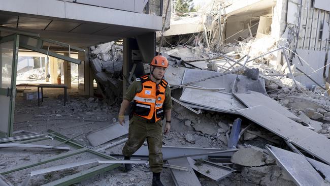 An emergency responder inspects damage of a school in the city after an earlier rocket strike, allegedly fired from Yemen on Thursday. Picture: Amir Levy/Getty Images