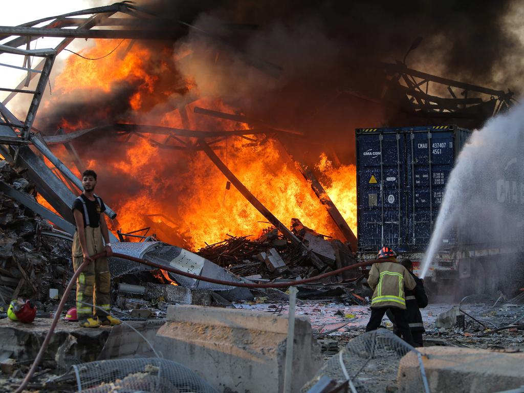 Firefighters douse a blaze at the scene. Picture: STR/AFP