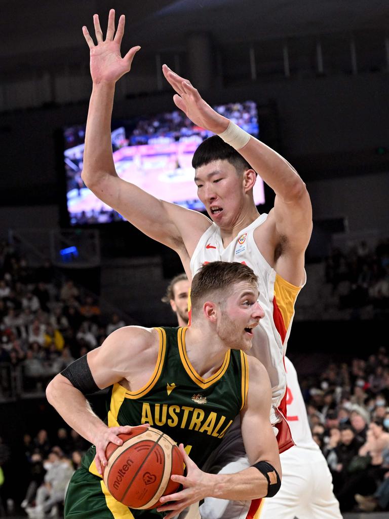 Australia's Jack White (front) drives past China's Zhou Qi during the FIBA Basketball World Cup 2023 qualifying game between Australia and China in Melbourne on June 30, 2022.