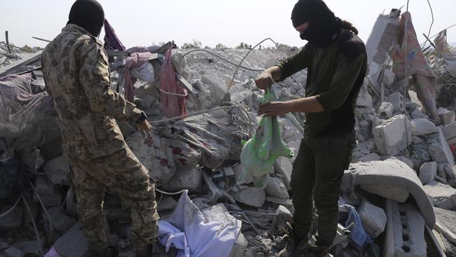 People sift through the rubble of a house destroyed in the strike. Picture: AP.