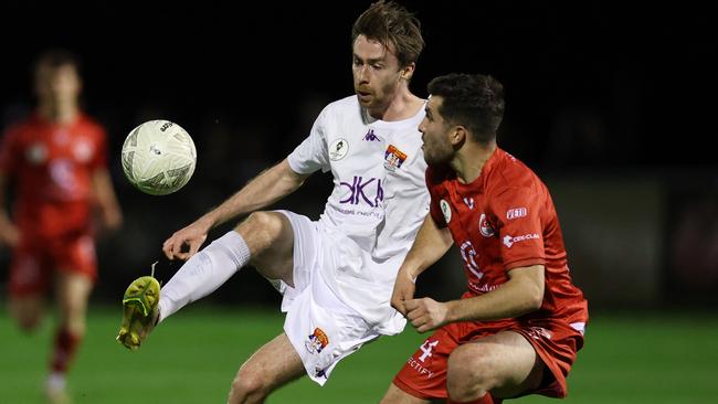 Ryan Brown of FC Melbourne takes on Hume City’s Lachlan Weier.