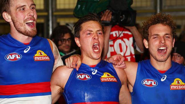 Bulldog Fergus Greene (centre) sings the club song in the rooms after winning against St Kilda. Picture: Getty Images