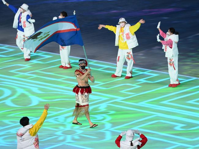 Crumpton of Team American Samoa carries this nation’s flag. Picture: Matthias Hangst/Getty Images