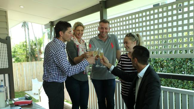 Place Graceville directors Brad Robson and Peter May with the new owner of 240 Long St East, Graceville, Kate Hill, celebrating with sellers Heidi Trevaskis and her husband Carl.