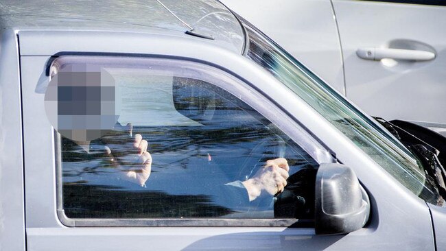 A driver talks on the phone while driving on Hoddle St, Collingwood. Picture: Mark Stewart