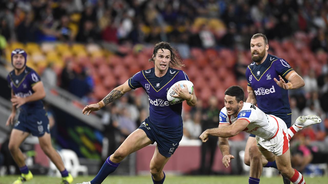 BRISBANE, AUSTRALIA – MAY 16: Nicho Hynes of the Storm evades the tackle from Ben Hunt of the Dragons during the round 10 NRL match between the Melbourne Storm and the St George Illawarra Dragons at Suncorp Stadium, on May 16, 2021, in Brisbane, Australia. (Photo by Albert Perez/Getty Images)