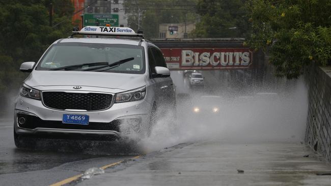 Traffic throws up water along Parramatta Road, North Strathfield. An east coast low hits Sydney after a week of heavy rain. Picture: John Appleyard