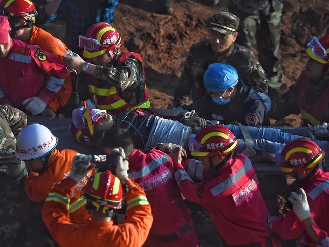 Getting help ... a survivor pulled out alive after he was buried for more than 70 hours. Picture: AP