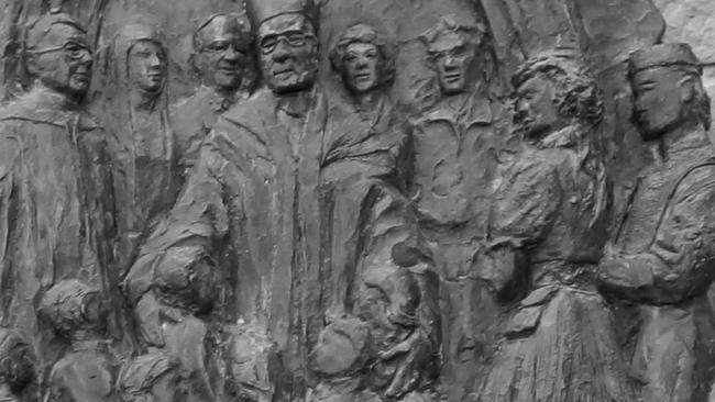 An artwork fixed to the side of St Mary's Cathedral that depicts former Archbishop Guilford Young, centre, and the former Monsignor Phillip Green, left, will be removed.