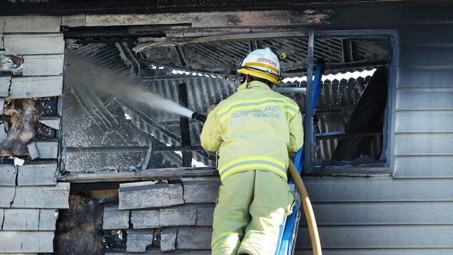 A firefighter fights the blaze at the newly renovated Wooloowin home. Picture; Liam Kidston.