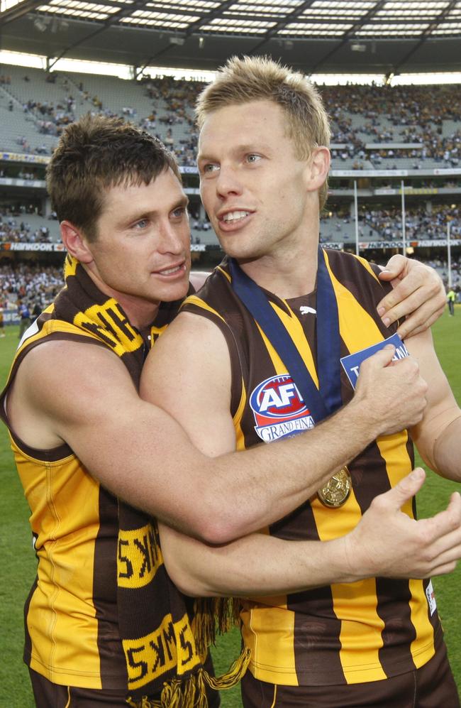 Shane Crawford and Sam Mitchell after the 2008 grand final.