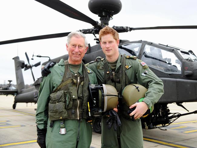 Prince Charles and Prince Harry stand in front of an Apache helicopter in 2011. Picture: Getty Images