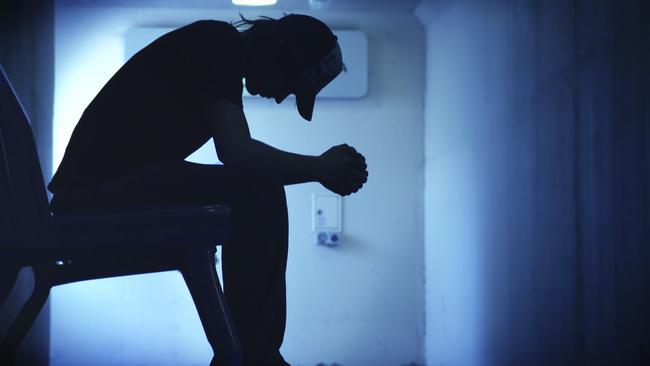 Young man with hands clasped together