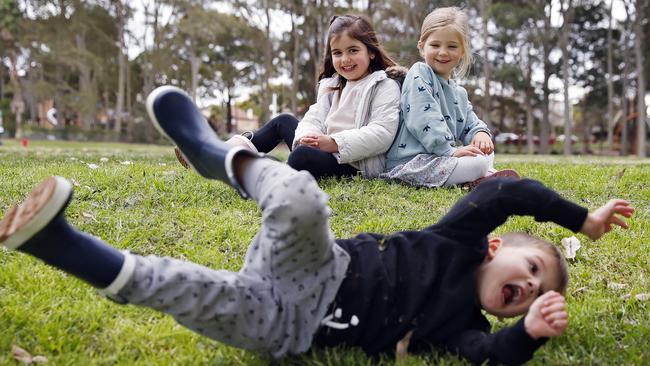 Brooklyn Bacic (rolling down hill), Tara Tevanian and Emmeline Donohue playing through the late winter cold snap., Picture: Sam Ruttyn