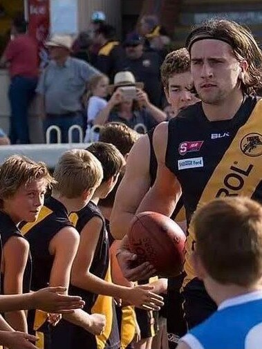 Max Proud runs onto Glenelg Oval watched by a young Archie Lovelock. Picture: Supplied