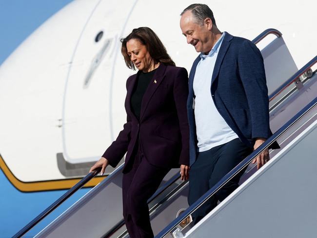 US Vice President and 2024 Democratic presidential candidate Kamala Harris and Second Gentleman Doug Emhoff step off Air Force Two as they arrive at Joint Base Andrews, Maryland, on August 23, 2024. (Photo by Kevin Lamarque / POOL / AFP)