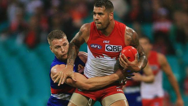 Jake Stringer tries to tackle Lance Franklin. Picture: Toby Zerna