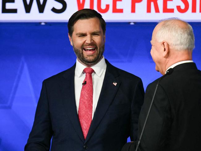 TOPSHOT - US Senator and Republican vice presidential candidate J.D. Vance (L) and Minnesota Governor and Democratic vice presidential candidate Tim Walz talk with each other at the end of the Vice Presidential debate hosted by CBS News at the CBS Broadcast Center in New York City on October 1, 2024. (Photo by ANGELA WEISS / AFP)