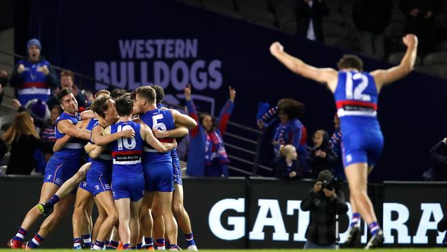 Bulldogs players celebrate following Taylor’s miss after the final siren.